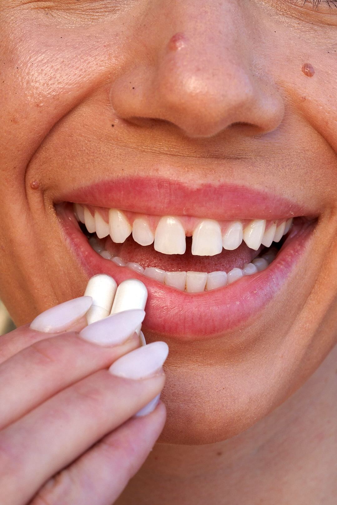 Woman taking Khelp heartburn relief capsules