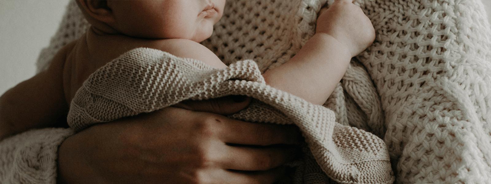 Postpartum mom holding baby